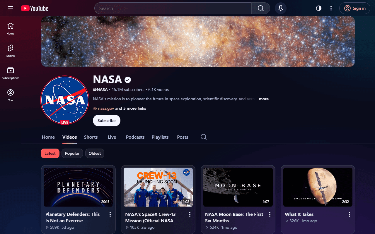 NASA’s YouTube channel in the Glass theme: frosted header and video cards over a soft red and violet glow.