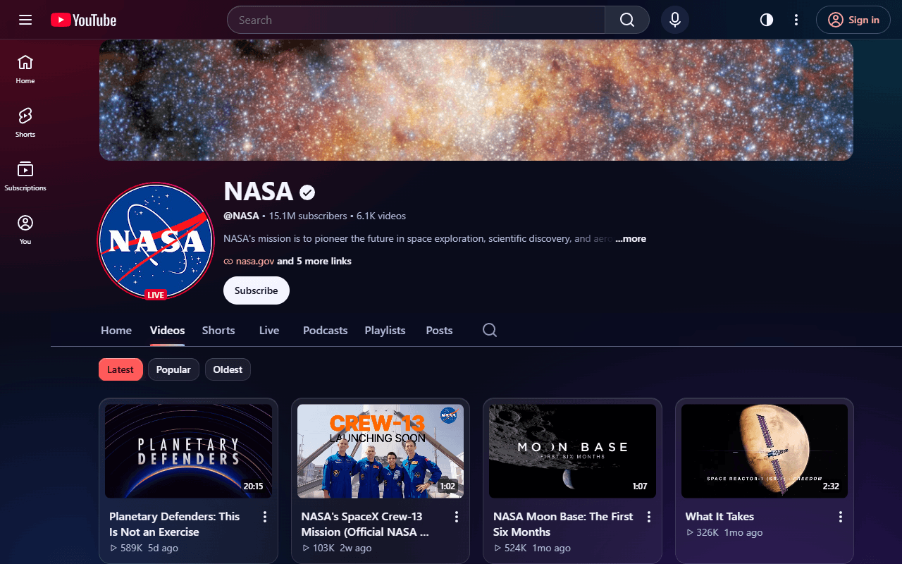 NASA’s YouTube channel in the Glass theme: frosted header and video cards over a soft red and violet glow.